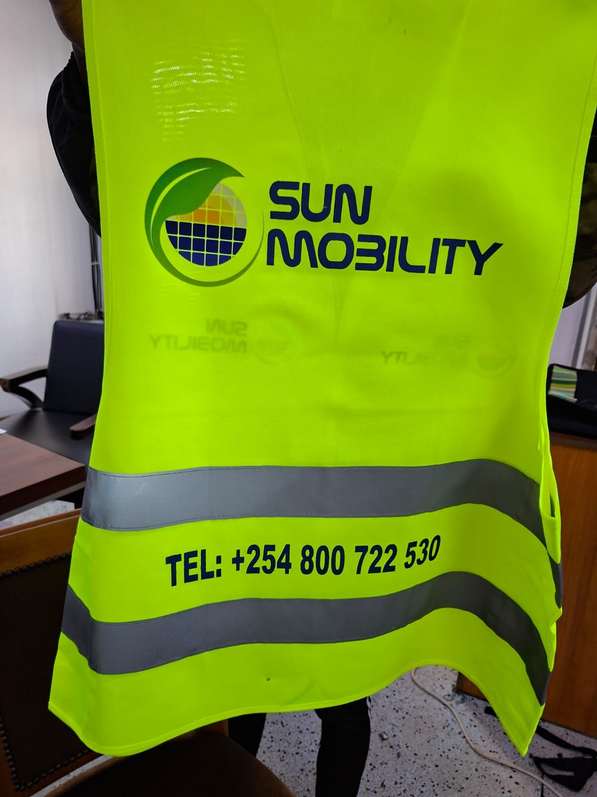 Lime green Sun Mobility branded high-visibility safety vest