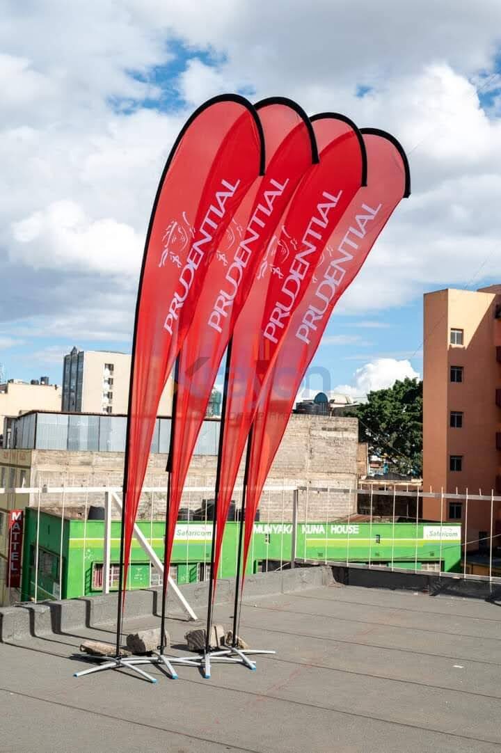 Red Prudential branded feather flags installed outdoors on a rooftop